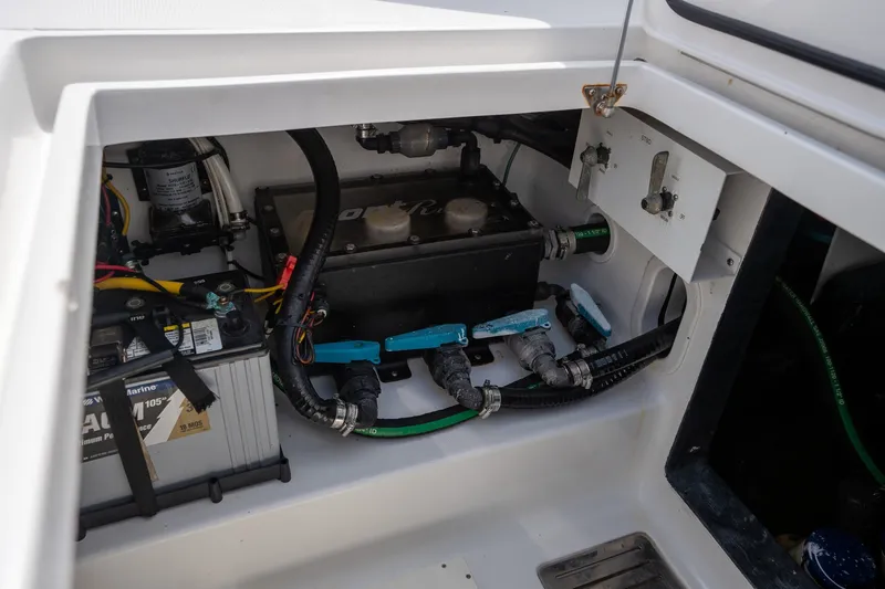 Slide: The Image of 2023 Front Runner 39 Center Console boat engine compartment with battery and wiring. - 25