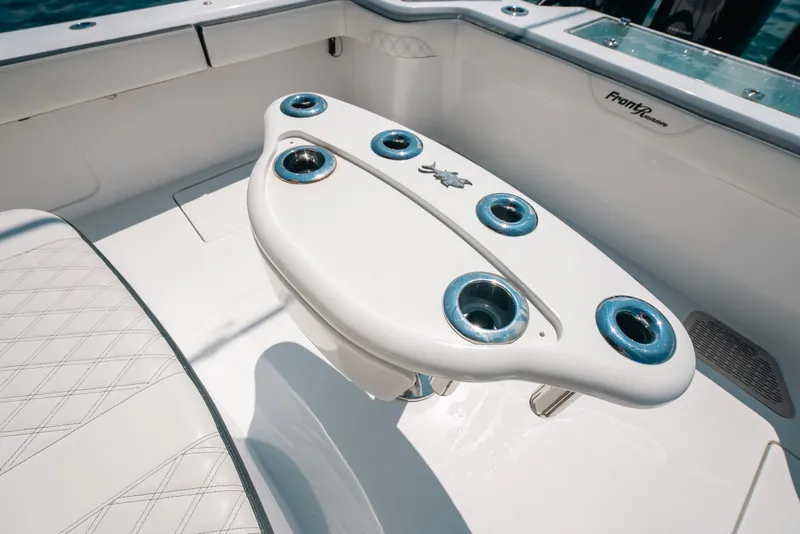 Slide: The Image of 2023 Front Runner 39 Center Console boat interior with rod holders and seating. - 70