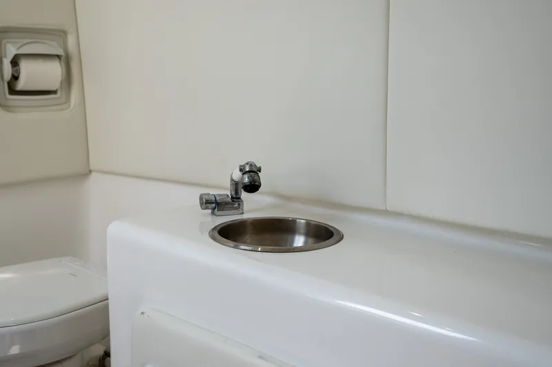 Slide: The Image of Interior of 2023 Front Runner 39 Center Console boat bathroom with sink and toilet. - 46