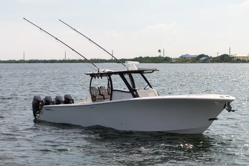Slide: The Image of 2023 Front Runner 39 Center Console boat on calm water with fishing rods. - 8