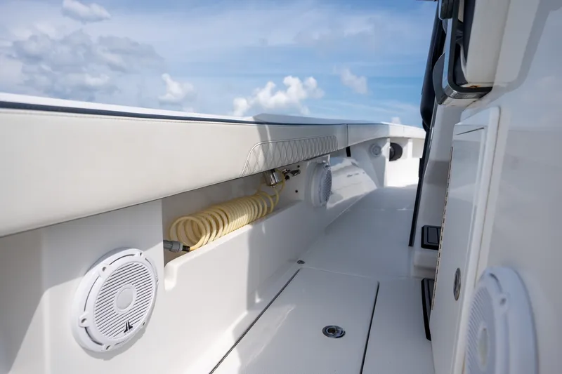 Slide: The Image of 2023 Front Runner 39 Center Console boat interior with speakers and coiled hose. - 44