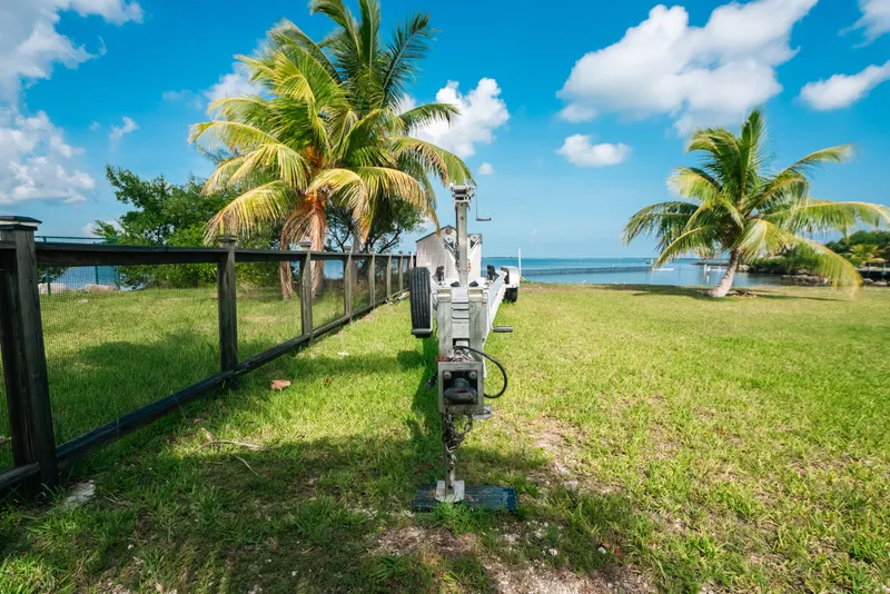 Slide: The Image of Trailer for 2023 Front Runner 39 Center Console by tropical beach with palm trees. - 82