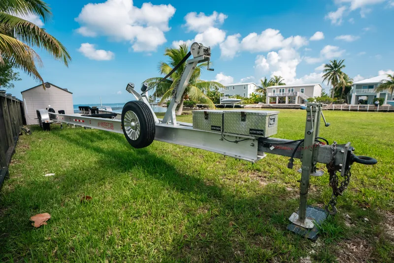 Slide: The Image of Trailer for 2023 Front Runner 39 Center Console on grassy lawn with palm trees. - 81