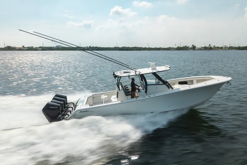 Slide: The Image of 2023 Front Runner 39 Center Console boat speeding on water with triple Mercury engines. - 4