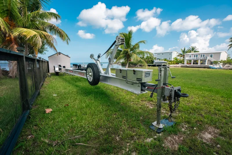 Slide: The Image of Trailer for 2023 Front Runner 39 Center Console on grassy lawn with palm trees. - 80