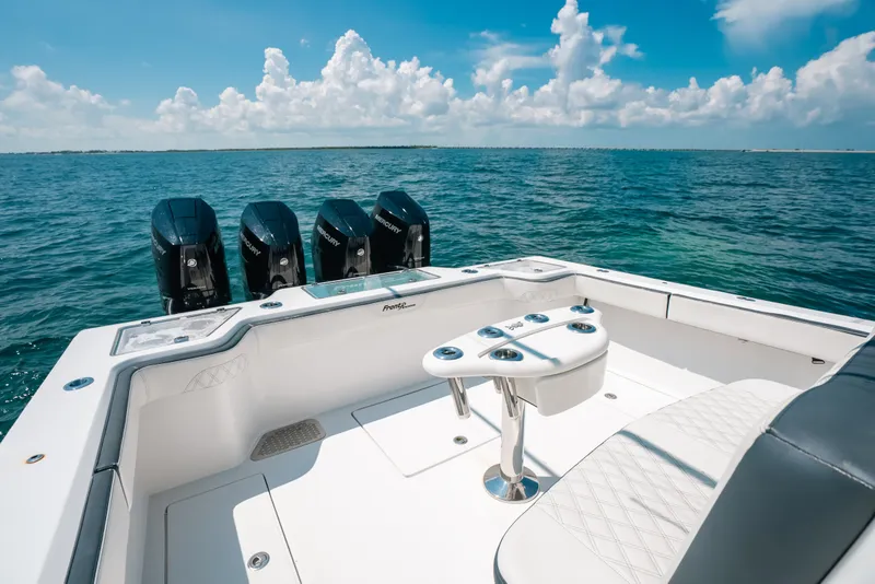 Slide: The Image of 2023 Front Runner 39 Center Console boat with quad Mercury engines on open water. - 54