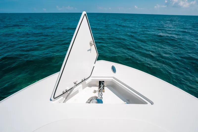 Slide: The Image of Open anchor hatch on 2023 Front Runner 39 Center Console boat, ocean view. - 52