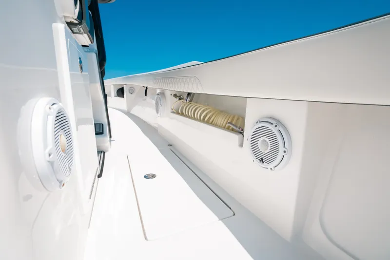 Slide: The Image of 2023 Front Runner 39 Center Console boat interior with speakers and hose storage. - 75