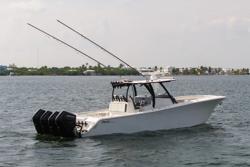 Slide: The Image of 2023 Front Runner 39 Center Console boat on water, equipped with multiple outboard engines. - 7