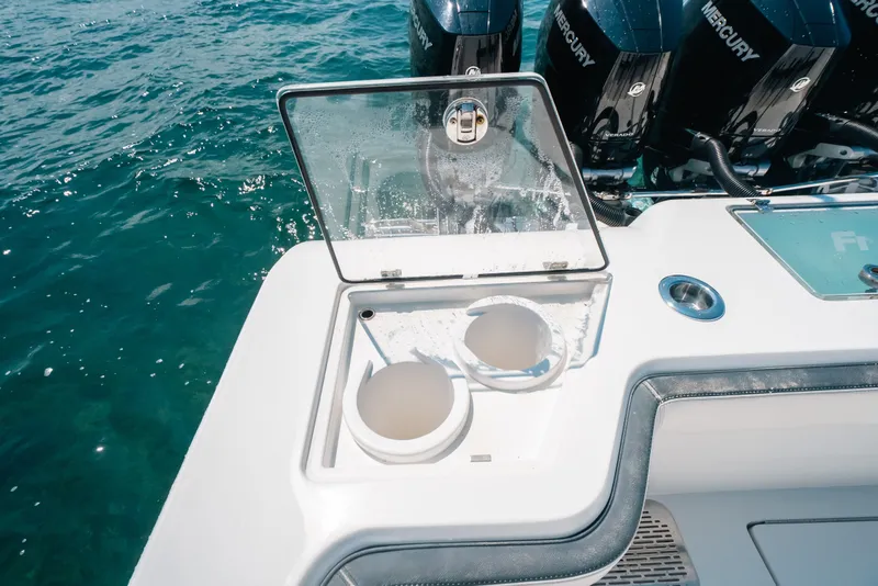 Slide: The Image of 2023 Front Runner 39 Center Console boat with open storage compartment and Mercury engines. - 56