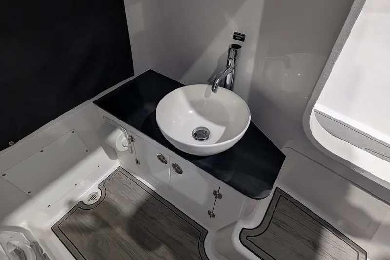 Slide: The Image of Modern bathroom interior of 2027 Monterey Elite 23 OB boat, featuring sleek sink and fixtures. - 18