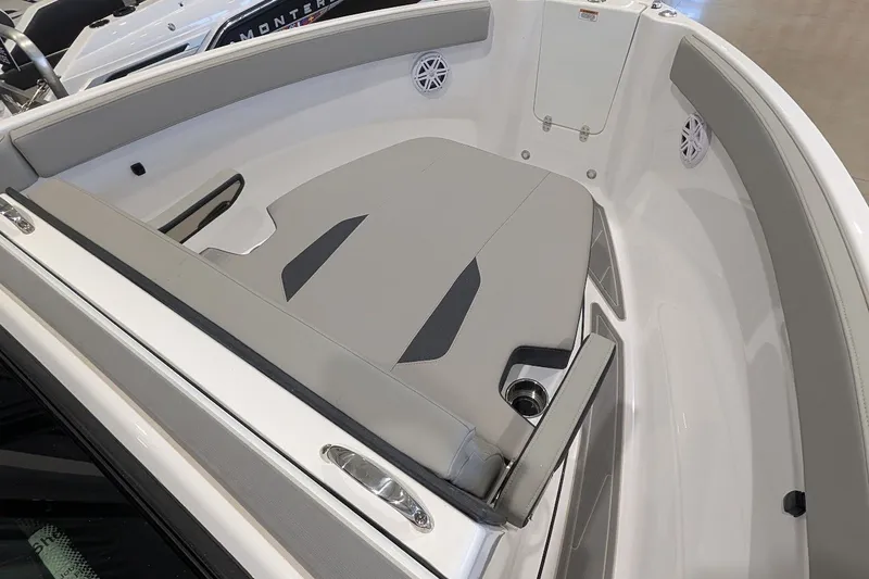 Slide: The Image of 2027 Monterey Elite 23 OB boat interior with gray seating and cup holders. - 16