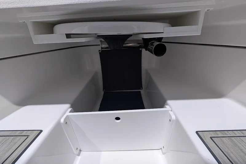 Slide: The Image of Interior view of 2027 Monterey Elite 23 OB boat, showcasing sleek white design and storage area. - 20