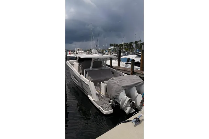 Slide: The Image of 2020 Regal 38 SAV boat docked at marina under cloudy sky. - 11