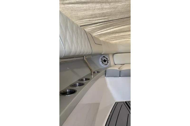 Slide: The Image of Luxurious interior of 2020 Regal 38 SAV boat with cup holders and speaker. - 56