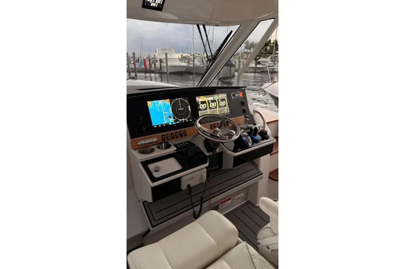 Slide: The Image of Helm of 2020 Regal 38 SAV boat with advanced navigation displays and controls. - 8