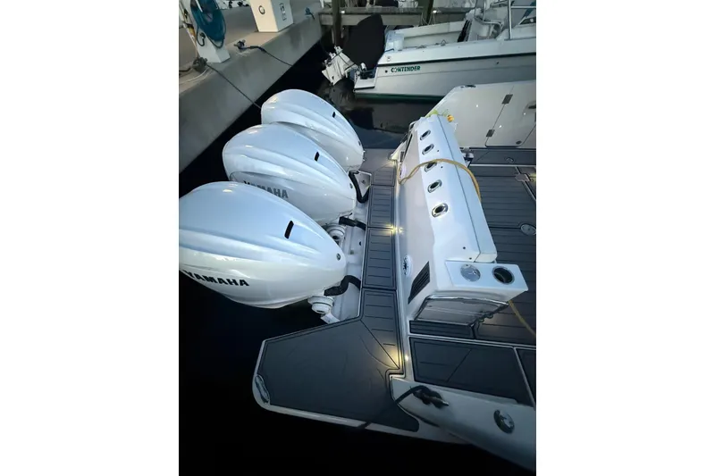 Slide: The Image of 2020 Regal 38 SAV boat with triple Yamaha outboard engines docked at marina. - 31