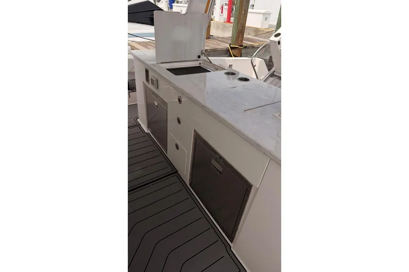 Slide: The Image of 2020 Regal 38 SAV boat galley with sleek countertops and storage cabinets. - 47