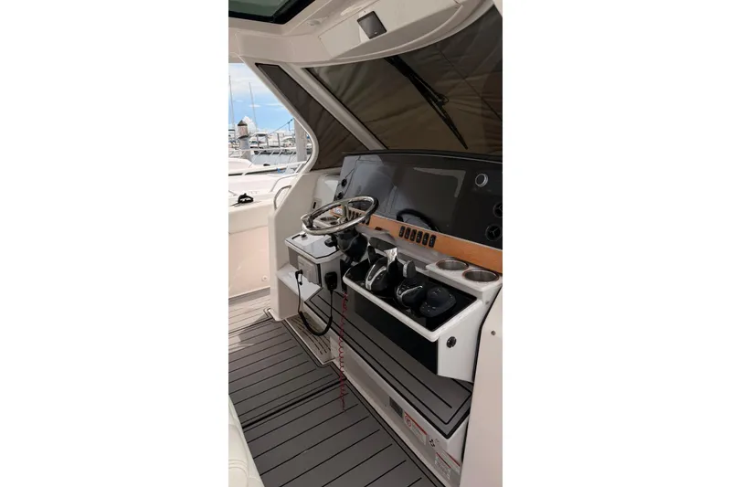Slide: The Image of 2020 Regal 38 SAV boat helm with modern controls and sleek design. - 46