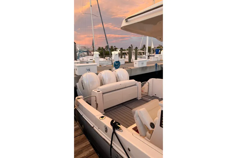 Slide: The Image of 2020 Regal 38 SAV boat docked at sunset, featuring Yamaha engines and sleek design. - 22