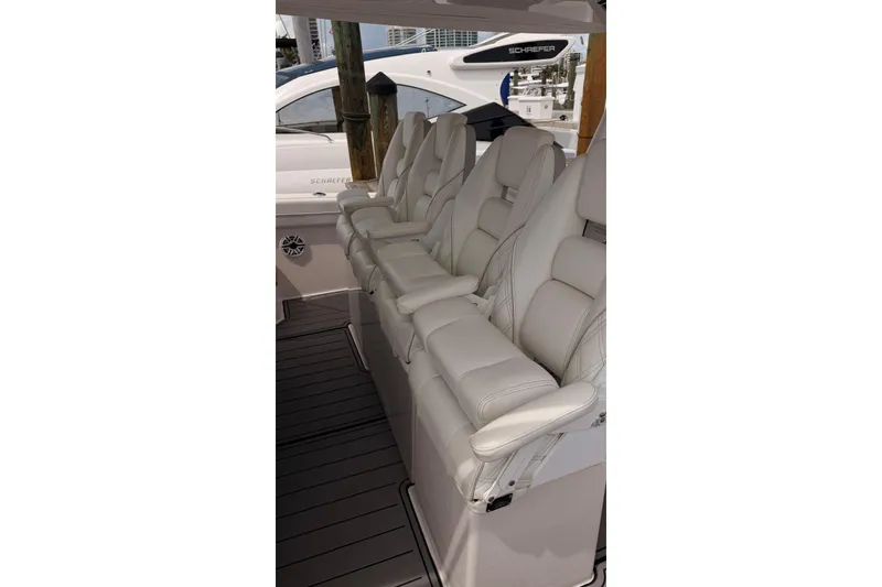 Slide: The Image of Luxurious white seating on a 2020 Regal 38 SAV boat, showcasing premium comfort. - 38