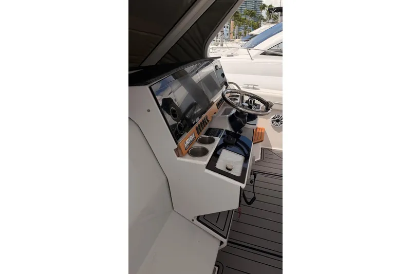 Slide: The Image of Cockpit of 2020 Regal 38 SAV boat with steering wheel and control panel. - 39