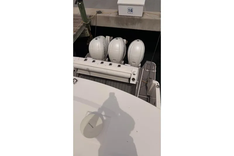 Slide: The Image of 2020 Regal 38 SAV boat with multiple outboard engines docked at marina. - 40