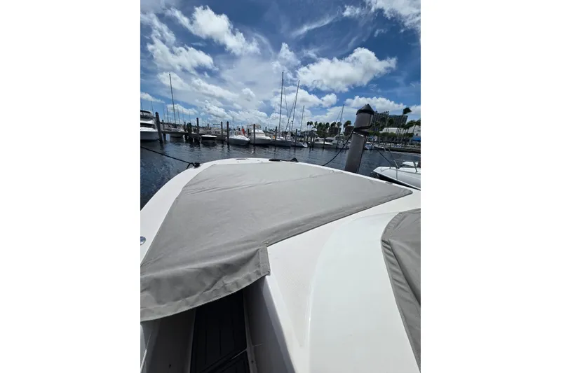 Slide: The Image of 2020 Regal 38 SAV boat docked at marina under blue sky. - 37