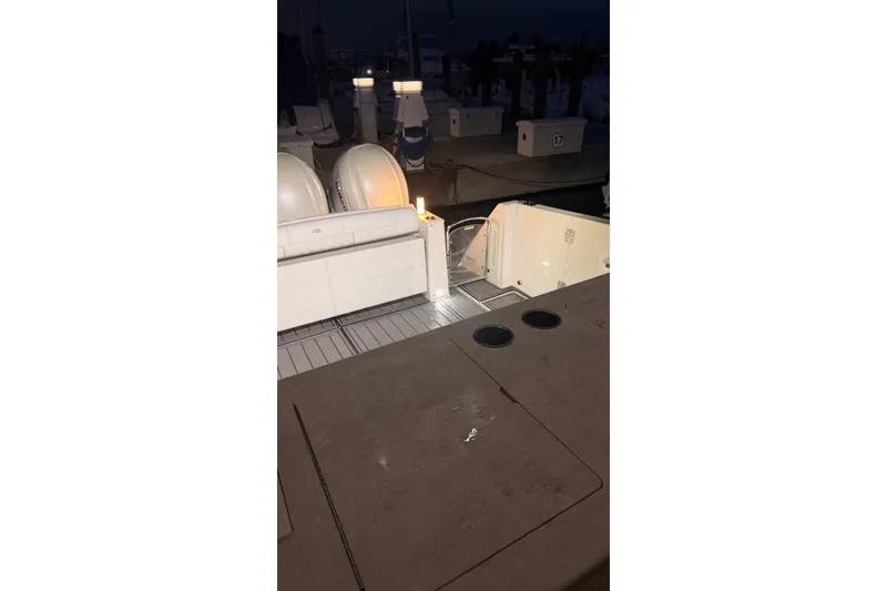 Slide: The Image of 2020 Regal 38 SAV boat interior at night, featuring seating and deck lighting. - 10