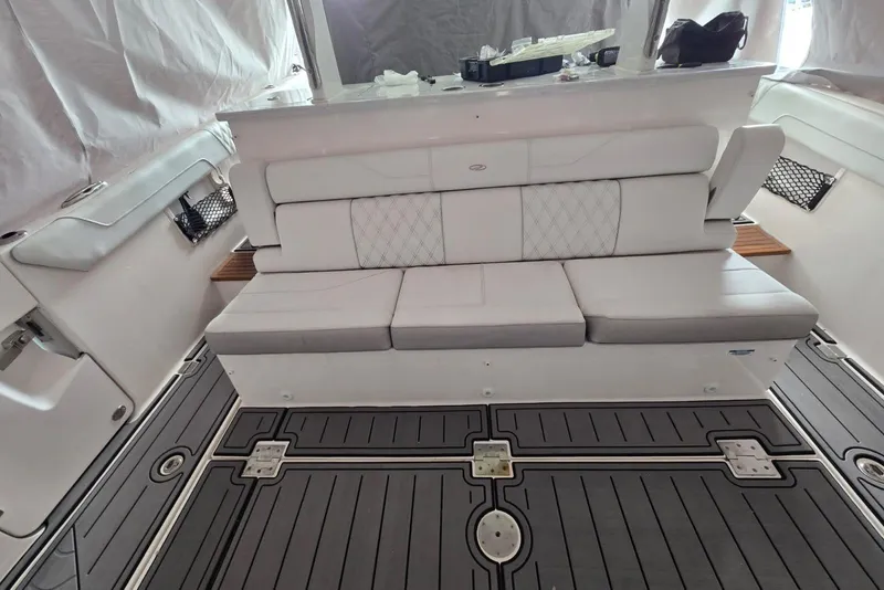 Slide: The Image of 2020 Regal 38 SAV boat interior with cushioned seating and sleek flooring. - 58