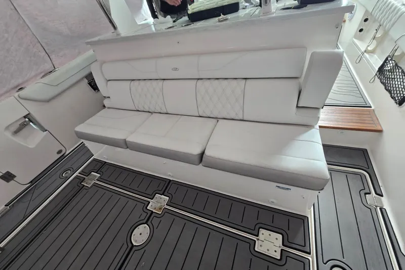 Slide: The Image of Interior seating of 2020 Regal 38 SAV boat with cushioned bench and sleek flooring. - 57