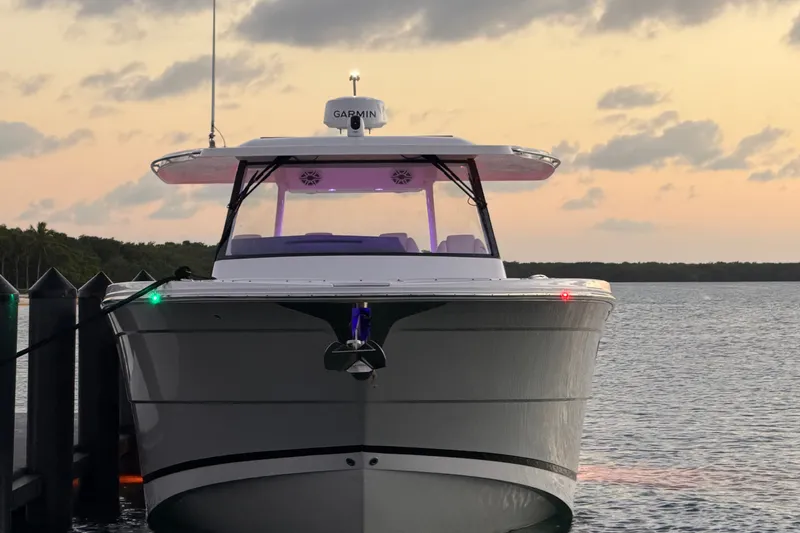 Slide: The Image of 2020 Regal 38 SAV boat docked at sunset with Garmin equipment. - 18