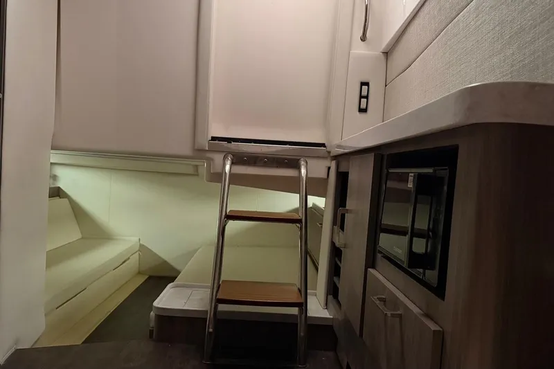 Slide: The Image of Interior of 2020 Regal 38 SAV boat with ladder, kitchenette, and seating area. - 48
