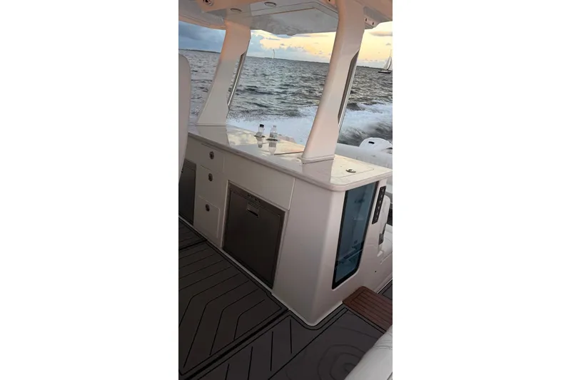 Slide: The Image of 2020 Regal 38 SAV boat interior with sleek cabinetry and ocean view. - 7