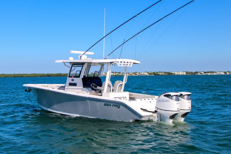 Slide: The Image of 2023 Sea Pro 320 DLX Offshore boat on open water, featuring dual Suzuki engines. - 3