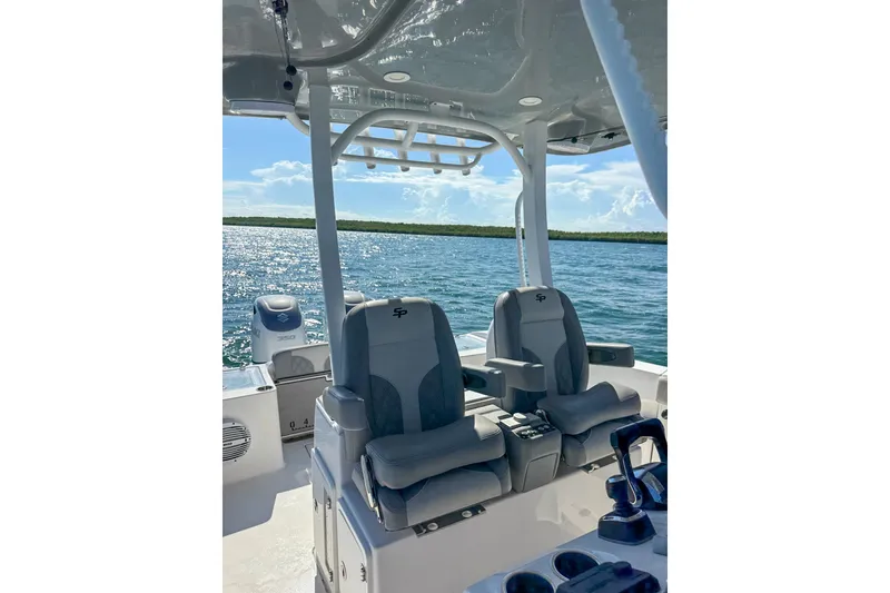 Slide: The Image of 2023 Sea Pro 320 DLX Offshore boat interior with dual seats on open water. - 20