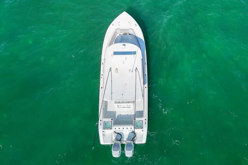 Slide: The Image of Overhead view of 2023 Sea Pro 320 DLX Offshore boat on clear green water. - 8