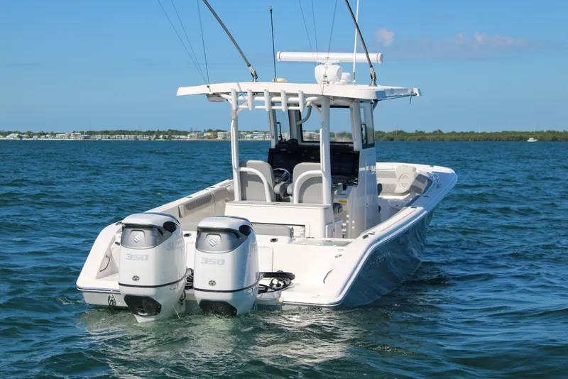 Slide: The Image of 2023 Sea Pro 320 DLX Offshore boat with dual engines on open water. - 5