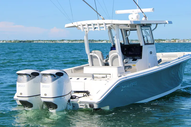 Slide: The Image of 2023 Sea Pro 320 DLX Offshore boat with dual Suzuki engines on open water. - 6