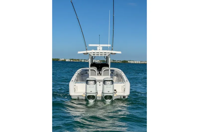 Slide: The Image of 2023 Sea Pro 320 DLX Offshore boat with dual engines on open water. - 10