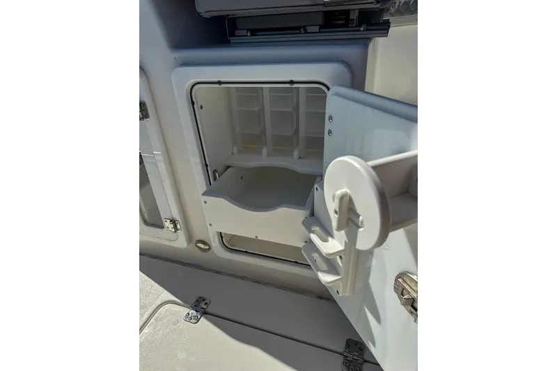 Slide: The Image of Open storage compartment on 2023 Sea Pro 320 DLX Offshore boat. - 25