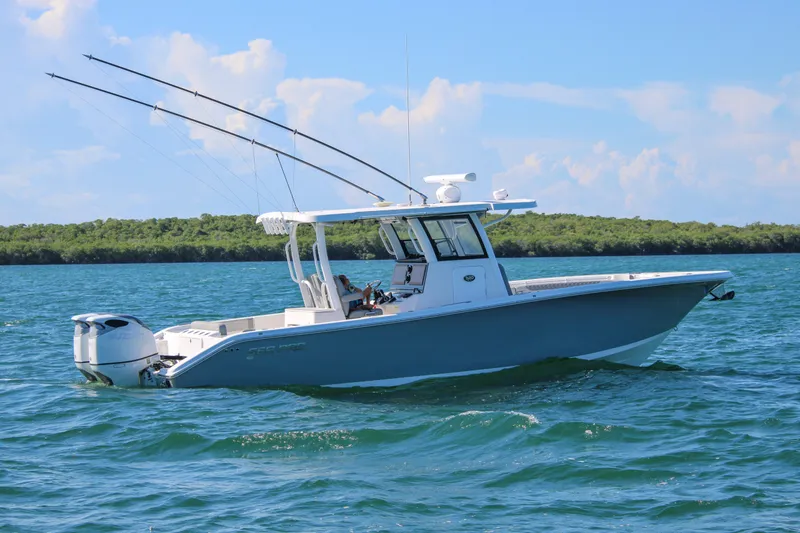 Slide: The Image of 2023 Sea Pro 320 DLX Offshore boat cruising on blue ocean waters. - 2