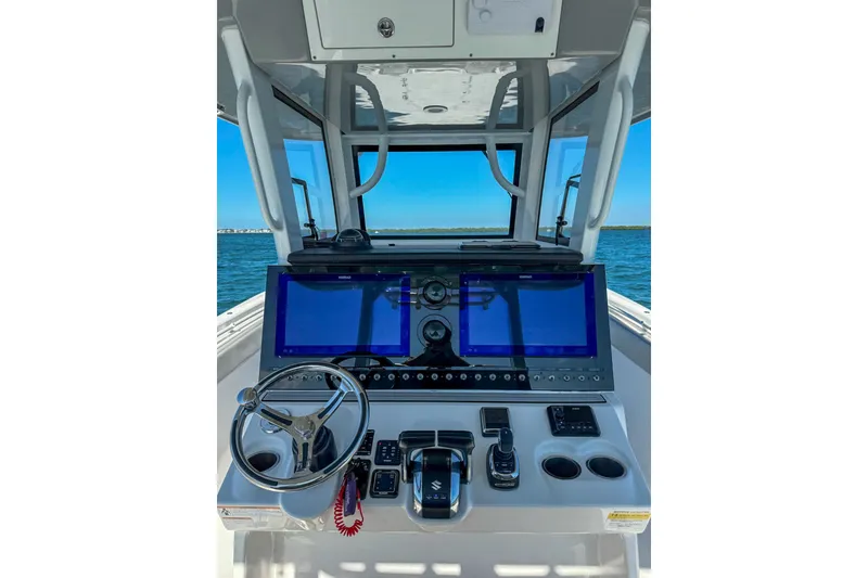 Slide: The Image of 2023 Sea Pro 320 DLX Offshore helm with dual screens and modern controls. - 22