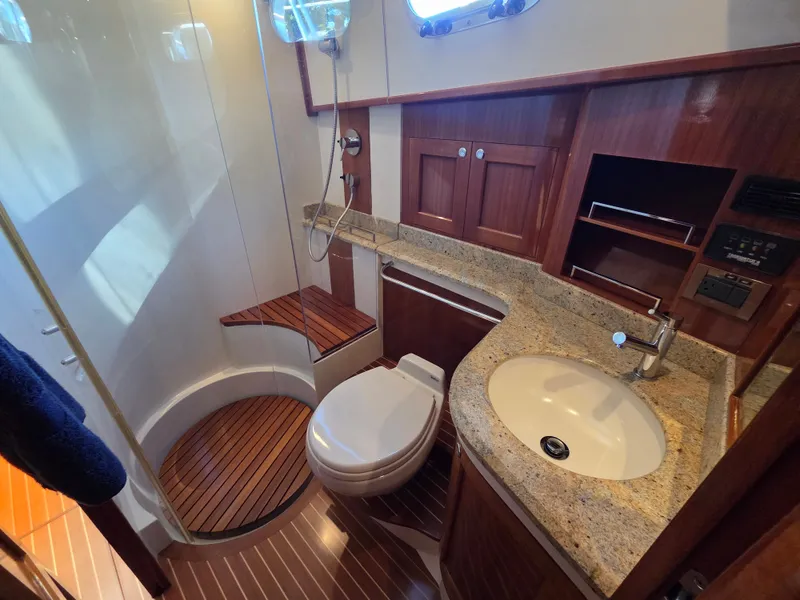 Slide: The Image of The image shows an elegant boat bathroom with wooden floors and a shower. - 30
