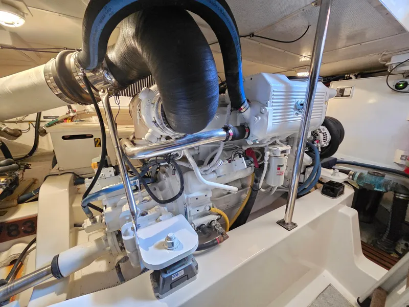 Slide: The Image of The engine room of a 2010 Grand Banks SX shows a clean, well-organized engine. - 37