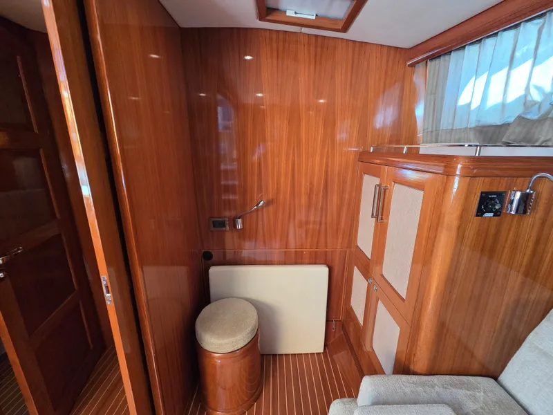 Slide: The Image of Interior of a 2010 Grand Banks SX with wooden walls and elegant furnishings. - 31