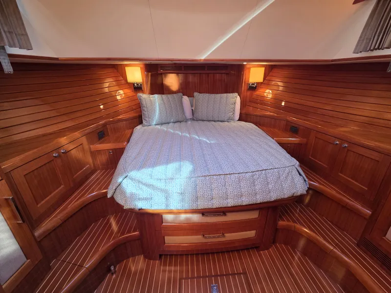 Slide: The Image of Grand Banks SX 2010: Cozy cabin with wooden walls, double bed, and soft lighting. - 25