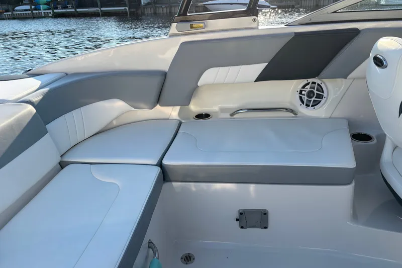 Slide: The Image of Interior seating of 2022 Chaparral 23 SSi OB boat, featuring white and gray upholstery. - 20