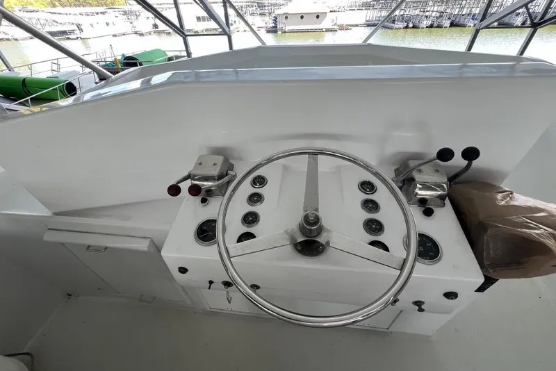 Slide: The Image of Helm of a 1976 Hatteras 53 Convertible yacht with steering wheel and controls. - 6