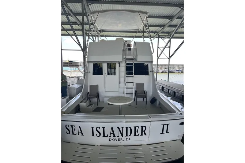 Slide: The Image of 1976 Hatteras 53 Convertible yacht docked, rear view, named "Sea Islander II". - 10